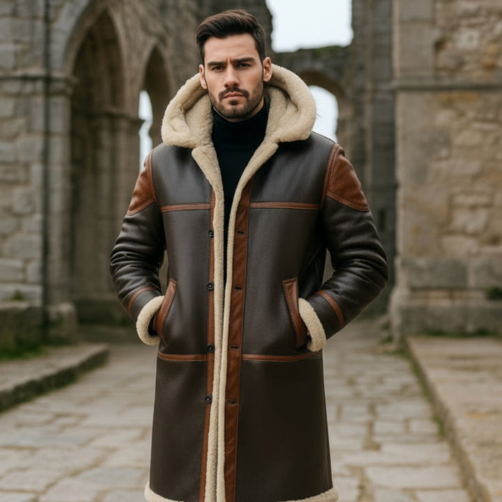 Man wearing a brown leather coat with fur lining in front of stone architecture.