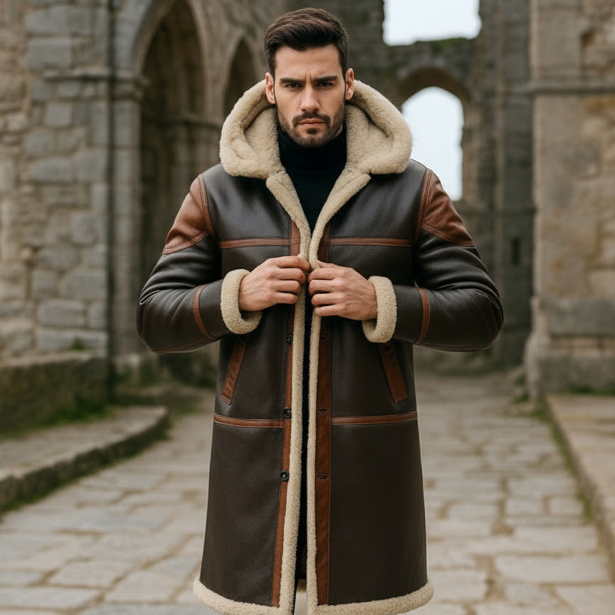 Man wearing a brown leather coat with fur lining in an outdoor setting.
